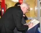 Archbishop Neill is among the first to sign the visitors book at the official opening of Castleknock National School's new extension.