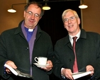 Bishop Michael Burrows and Michael Gleeson peruse their copies of Transient Beings by Patrick Semple at the book launch in the Knox Hall in Monkstown. 