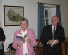 Reading from her memoir Over my Shoulder at the book’s launch is the Revd Norma MacMaster, watching (right) is Artist and Writer, Hugh Fitzgerald Ryan.