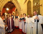 Archbishop Michael Jackson, Dean Dermot Dunne, servers and the choir of Christ Church before entering the cathedral at the Advent Carol Service on 27 November 2011.