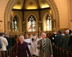 Led by the Churchwardens, the clergy process out of Booterstown Parish Church to the consecration of a new Garden of Remembrance for the parish.