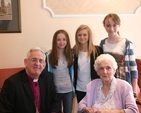 The Archbishop of Dublin, the Most Revd Dr John Neill and Olive Vaughan with three of Olive's great grandchildren on the occasion of Olive's 100th Birthday in Brabazon House.
