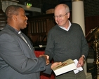 Prof Kjell Nordstokke presenting the Revd Obinna Ulogwara, Rector of St George and St Thomas' Parish, with a copy of his book 'Liberating Diakonia' as token of appreciation following the visit of a delegation from Diakonhjemmet University in Norway to the parish church.
