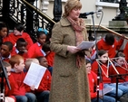 Diocesan Mothers’ Union President, Joy Gordon, reads at the Community Carol Singing outside the Mansion House on Saturday December 15.