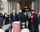 Archbishop Diarmuid Martin, Archbishop Michael Jackson and Vicar of St Ann’s Revd David Gillespie accompany the Seafield Singers and the children of the Catholic University School while the cameras capture the action during the Black Santa Appeal.