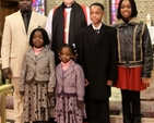 Archbishop Michael Jackson with the Okhueleigbe family following the Discovery International Carol Service in St George and St Thomas’s Church on December 8. 
