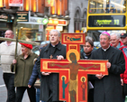 With Archbishops Michael Jackson and Diarmuid Martin at the front, the procession of the cross makes its way down Dame Street amidst heavy city centre traffic.