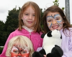 Three recently face-painted youngsters show off their new look.