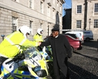 The former Archbishop of Cape Town, the Rt Revd Desmond Tutu greeting his Garda Motorcycle escort at the end of his visit to Trinity College Dublin.