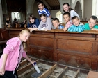 Members of St Mary’s, Blessington, Sunday School bury their time capsule under the new floor of their parish church to tell the people of the future what life is like today.  