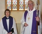 The Revd Adrienne Galligan, Rector of Crumlin and Chapelizod and the Archbishop of Dublin, the Most Revd Dr John Neill in front of one of two stained glass windows in St Laurence's Church, Chapelizod recently refurbished and re-dedicated. 