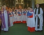Arcbishop Michael Jackson, Dean Dermot Dunne, Director of Music, Judith Gannon, and the choir of Christ Church cathedral in the chapter room following the Advent Carol Service in late November 2011.