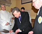 Church warden at St George’s Church in Balbriggan, Trevor Sargent, signs the register witnessed by the Archbishop of Dublin, the Most Revd Dr Michael Jackson and registrar, Canon Victor Stacey, at the Service of Introduction of the Revd Anthony Kelly as Bishop’s Curate of the parishes of Holmpatrick and Kenure with Balbriggan and Balrothery.