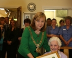 The Lord Mayor of Dublin, Cllr Emer Costello presenting 100 year old Olive Vaughan with a Certificate on her birthday in the Brabazon House.