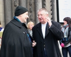 Archbishop Michael Jackson and Archbishop Diarmuid Martin share some festive cheer while the Seafield Singers perform in the background outside St Ann’s Church on Dawson Street.
