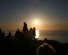 Worshipers silhouetted against the rising sun at the Ecumenical Easter Sonrise Service on Killiney Hill.