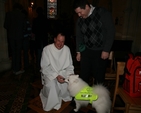 The Revd Roy Byrne, Rector of Drumcondra gets to know a four legged friend at the service in Christ Church Cathedral in aid of Peata.