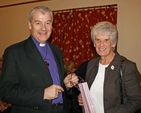 Archbishop Jackson presents a gift to Naomi Maybury following the re–dedication of the Mageough Home Chapel