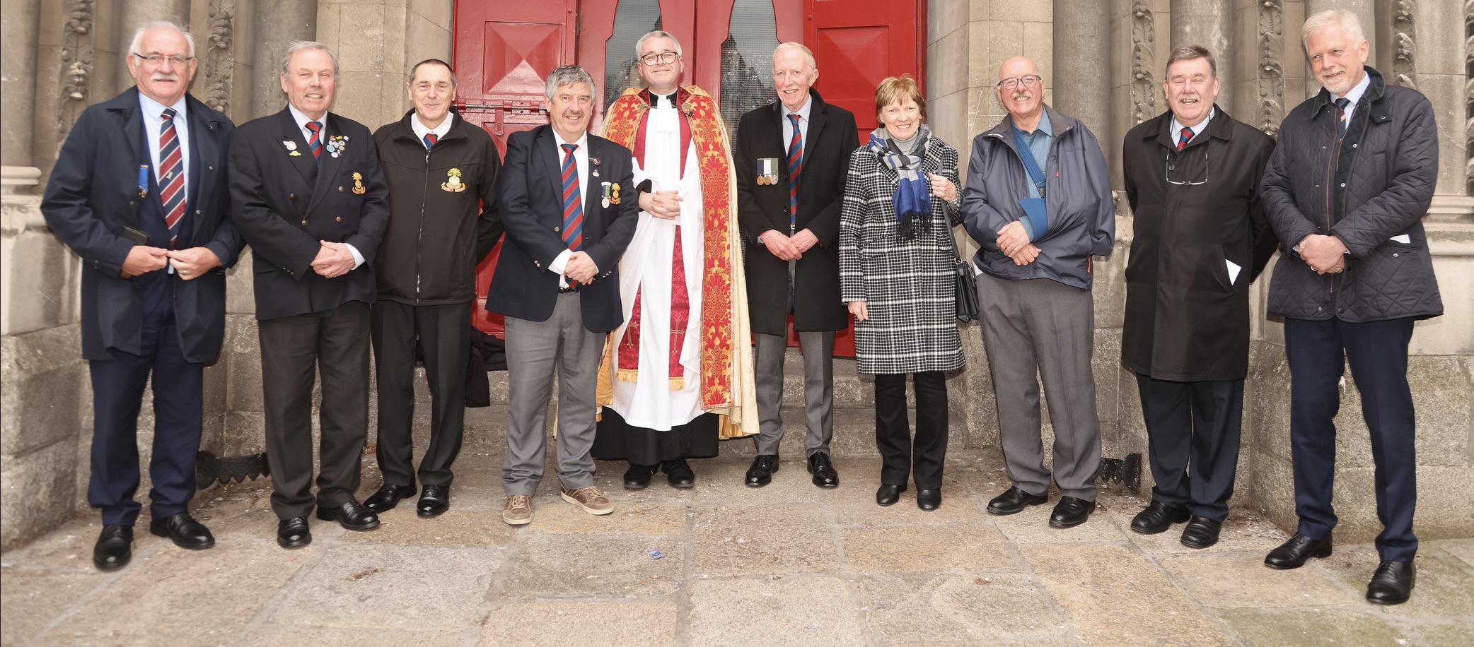 Canon Paul Arbuthnot with some of those attending the Anzac Day Service in St Ann's. Photo by Patrick Hugh Lynch.