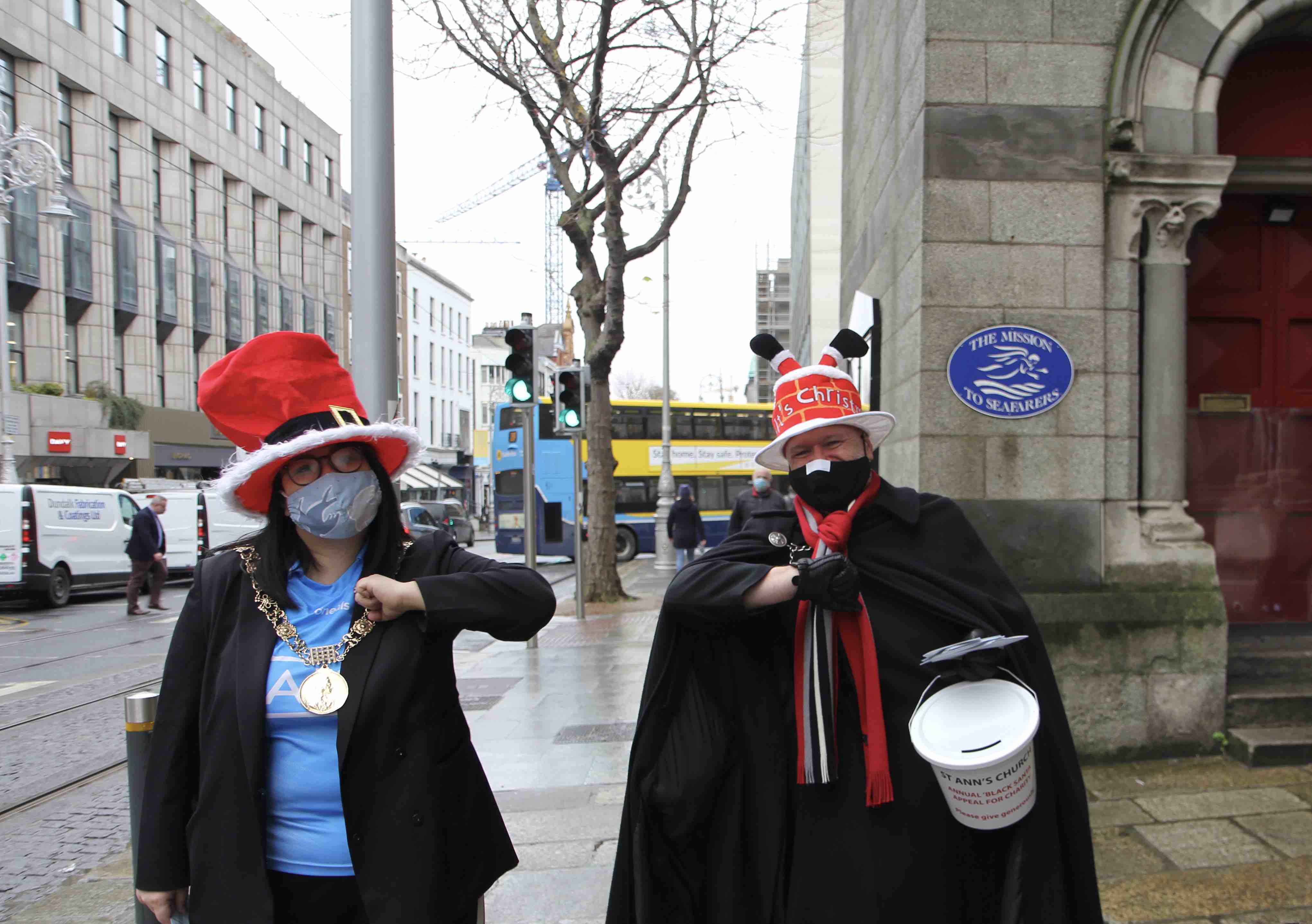 Lord Mayor Hazel Chu and Canon David Gillespie greet each other outside St Ann's Dawson Street at the launch of Black Santa 2020.