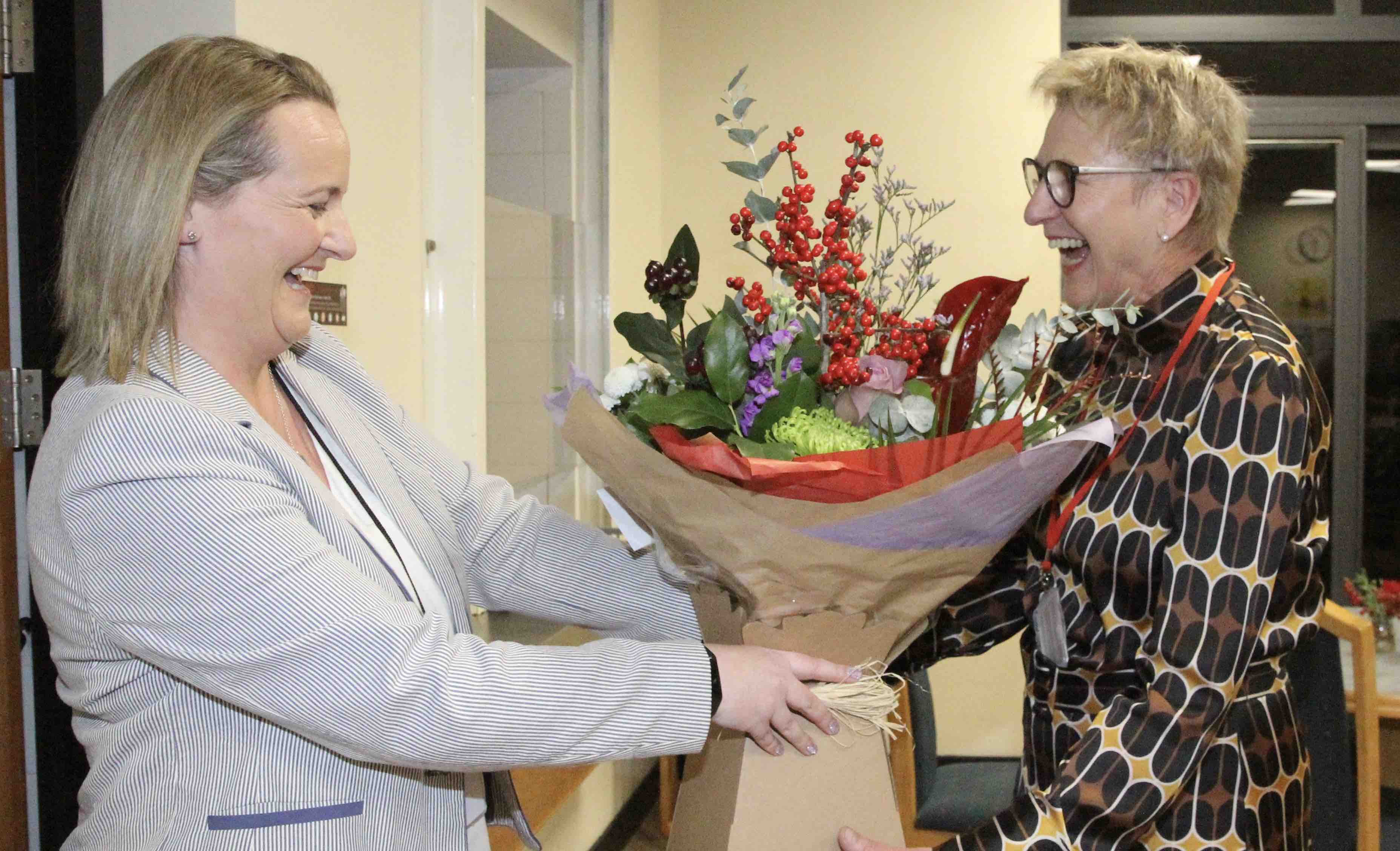 Diocesan Finance and Compliance Officer Caroline Cummins presents Sylvia with flowers.