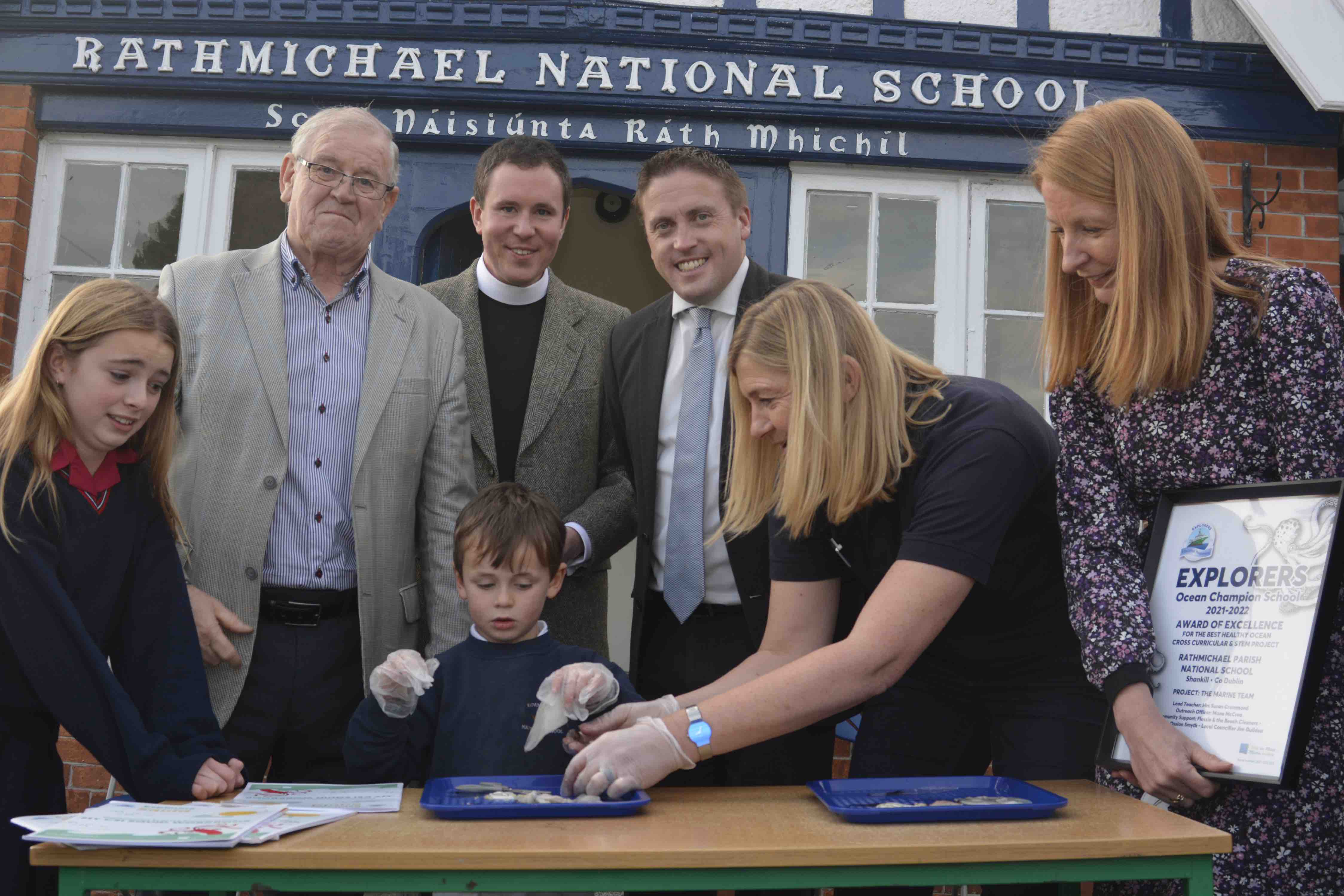 Cllr Jim Guidea and Deputy Cormac Devlin with the Revd Sean Hanily and Susan Crammond of Rathmichael along with Mona McCrea of the Marine Institute teaching two pupils how to dissect a squid.