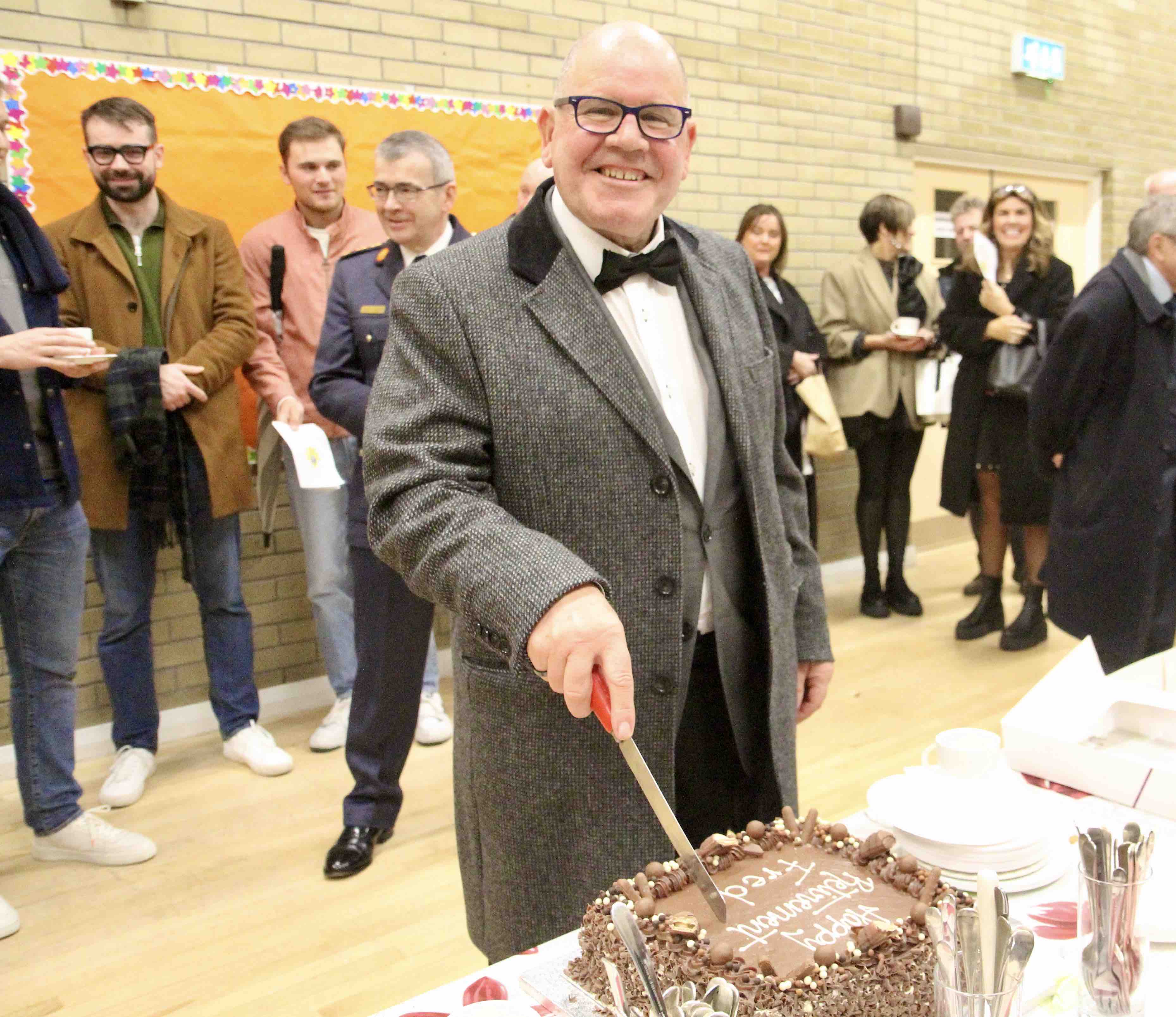 Fred Deane cuts his retirement cake.