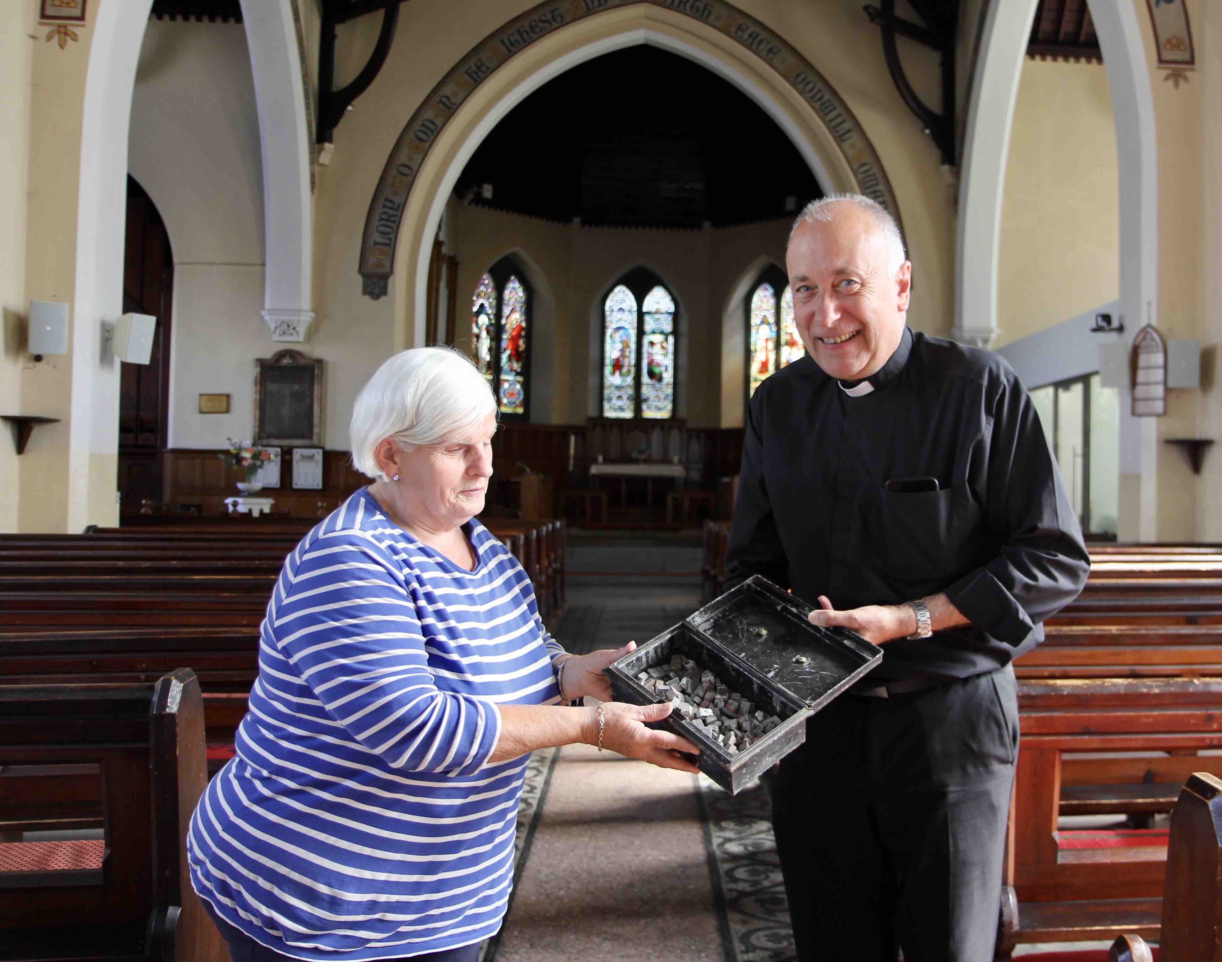 Longstanding parishioner Gladys Raethorne and Canon Leonard Ruddock examine the mosaic tiles which date from the church's extension in 1879.