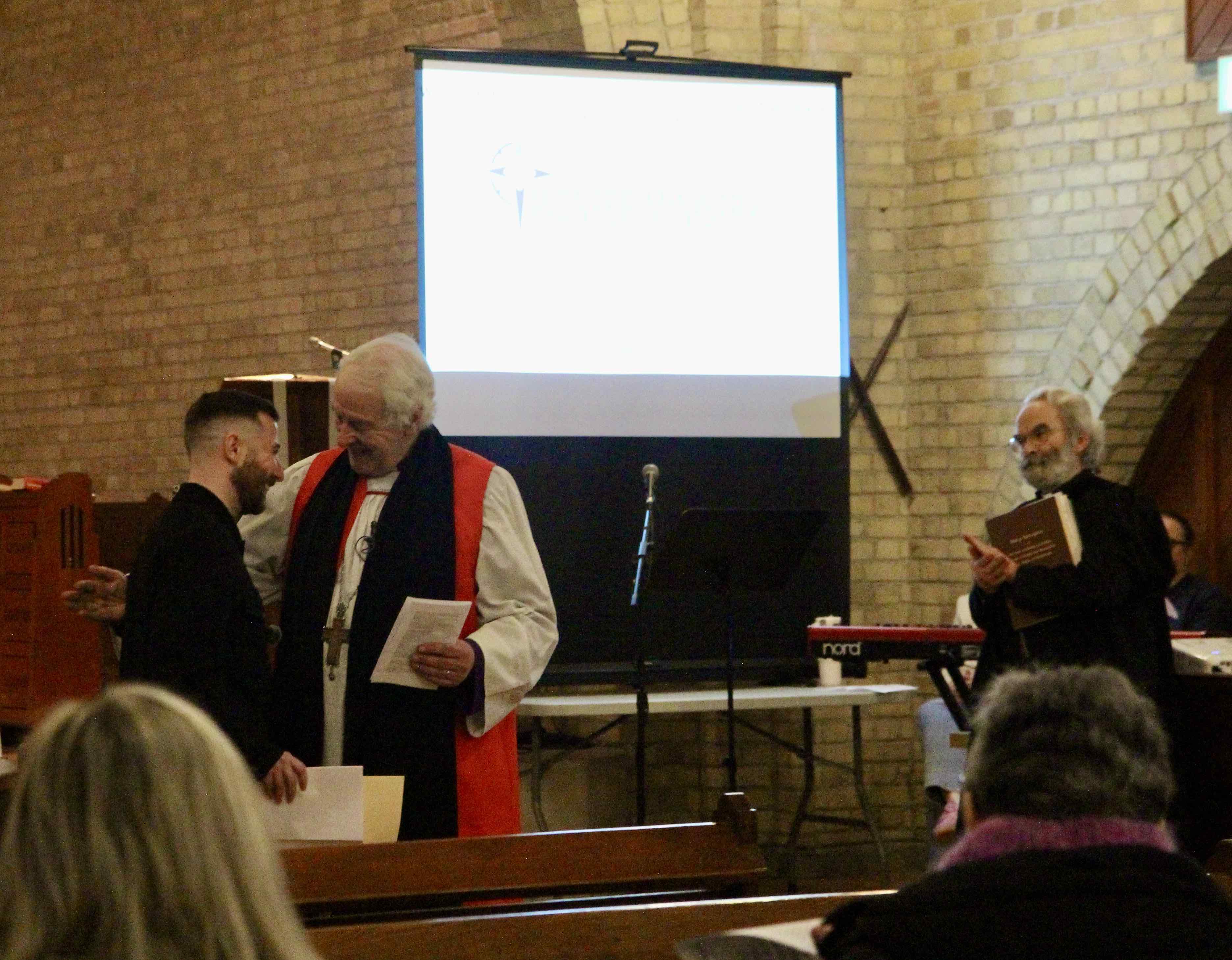 Shane is congratulated by the Archbishop following his commissioning.