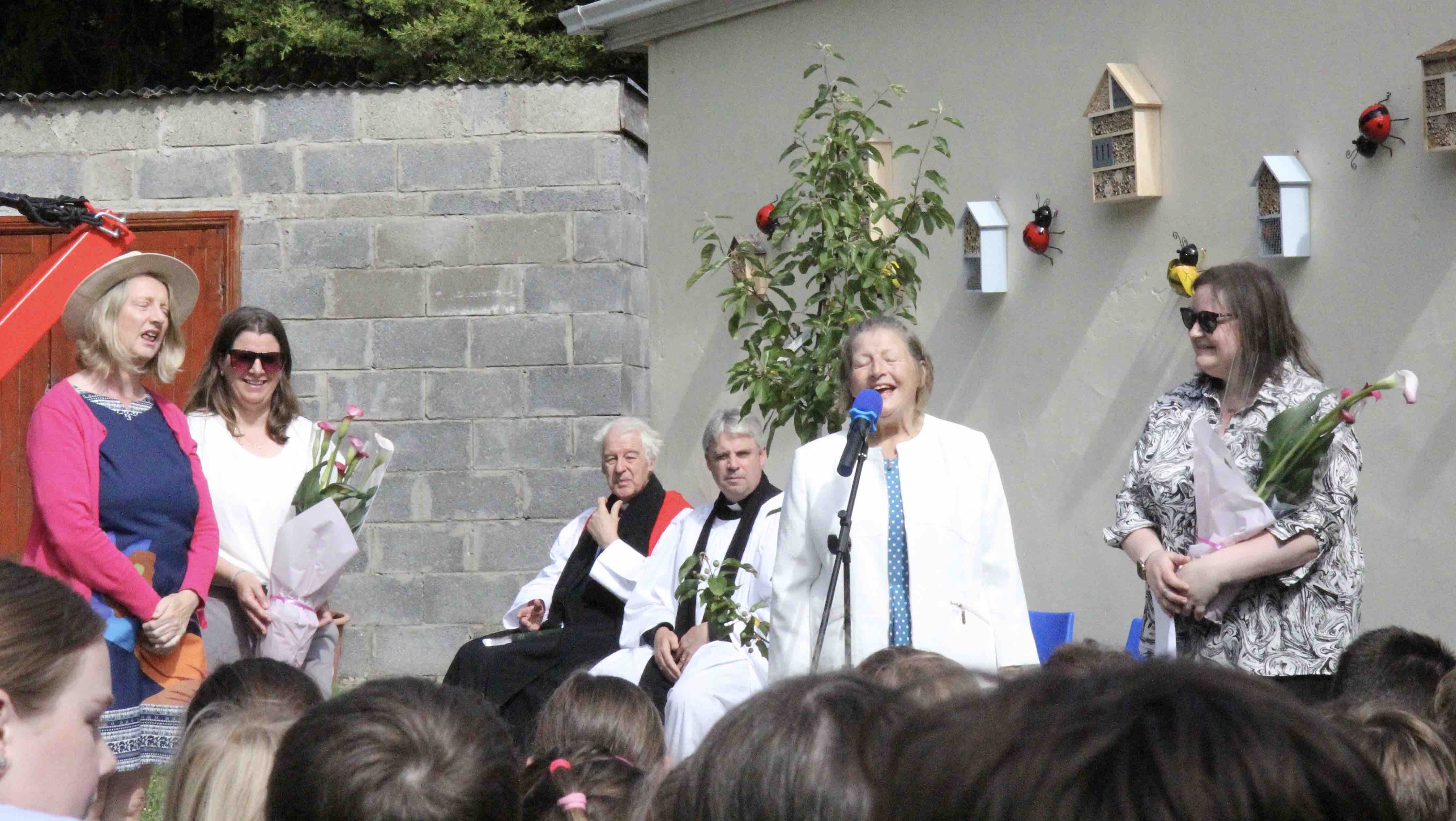 Erika Tynan and Cherry Sleeman are presented with flowers by Judy Brown and Sarah Richards.