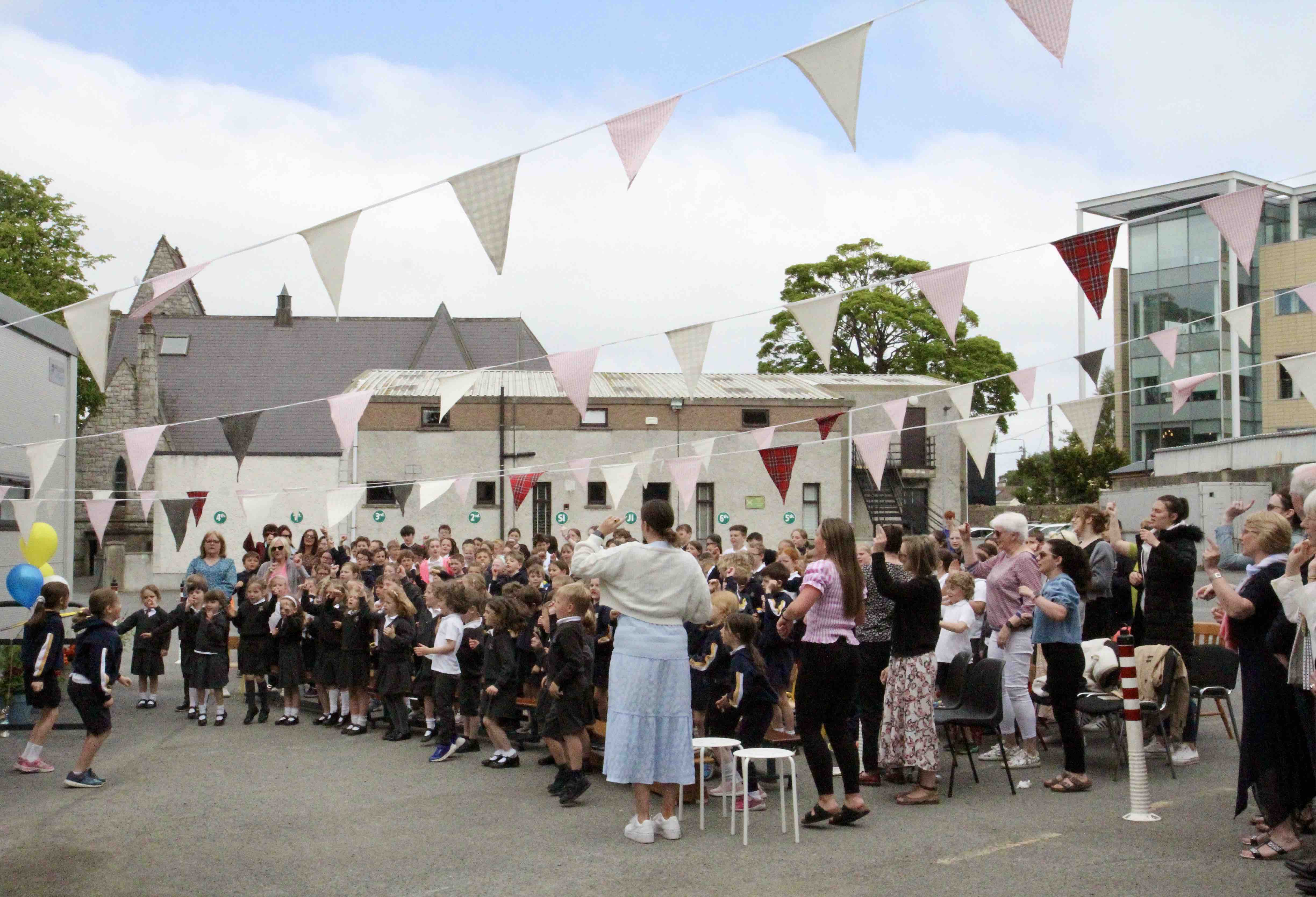 Pupils of Kill O' the Grange NS leading the singing at their open air assembly.