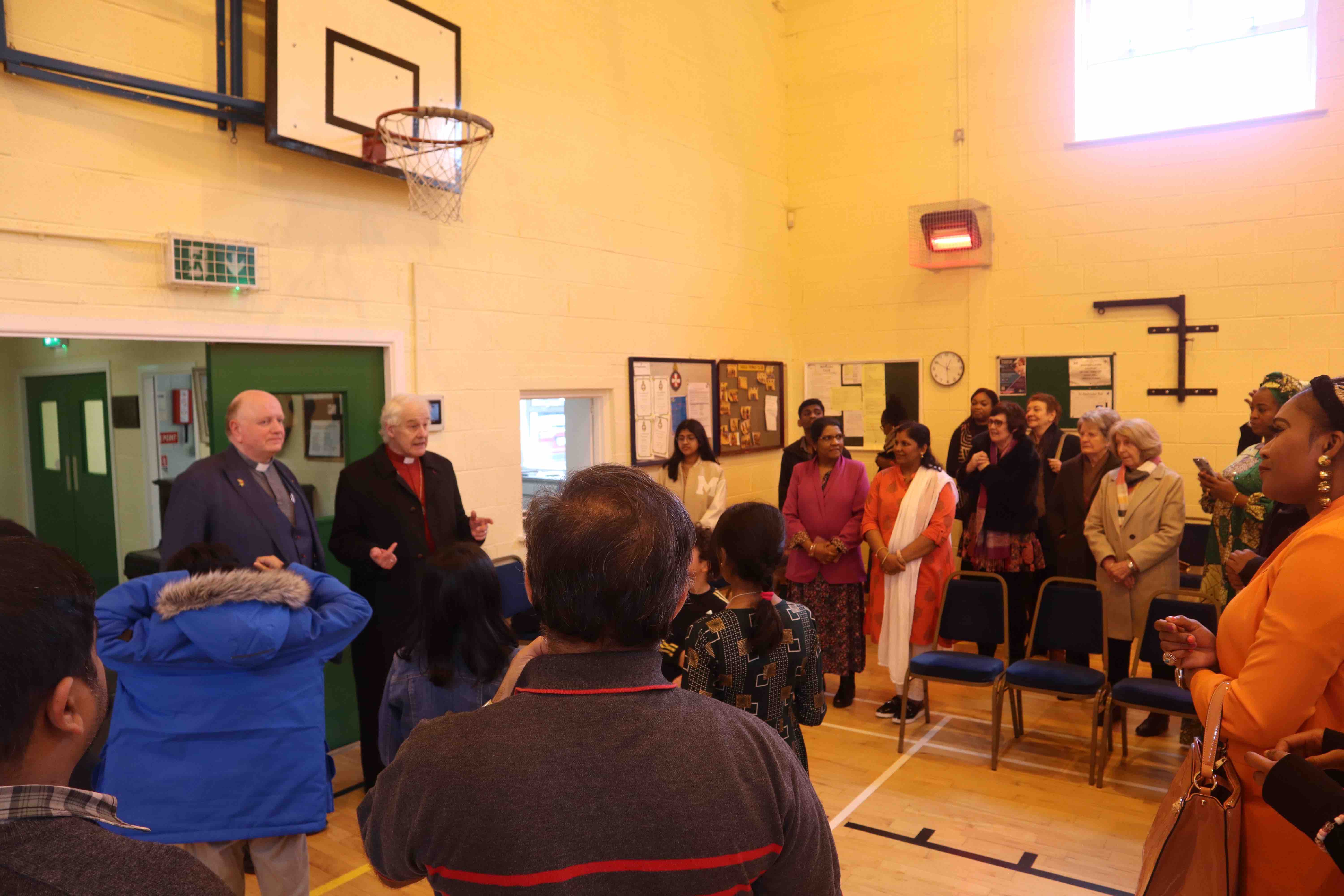 Canon William Deverell and Archbishop Michael Jackson talking to parishioners.