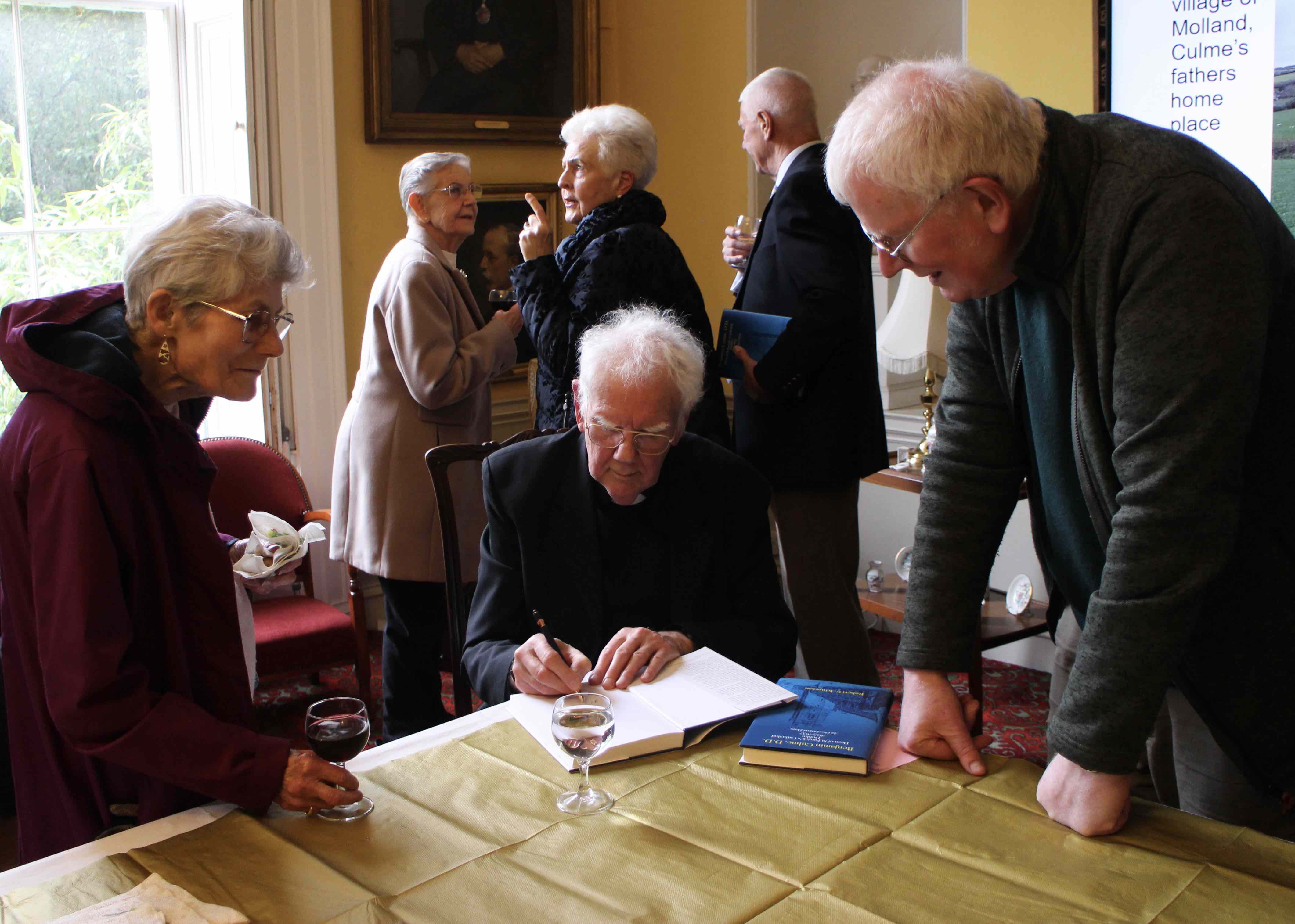 The Revd Robert Kingston signing copies of his book.