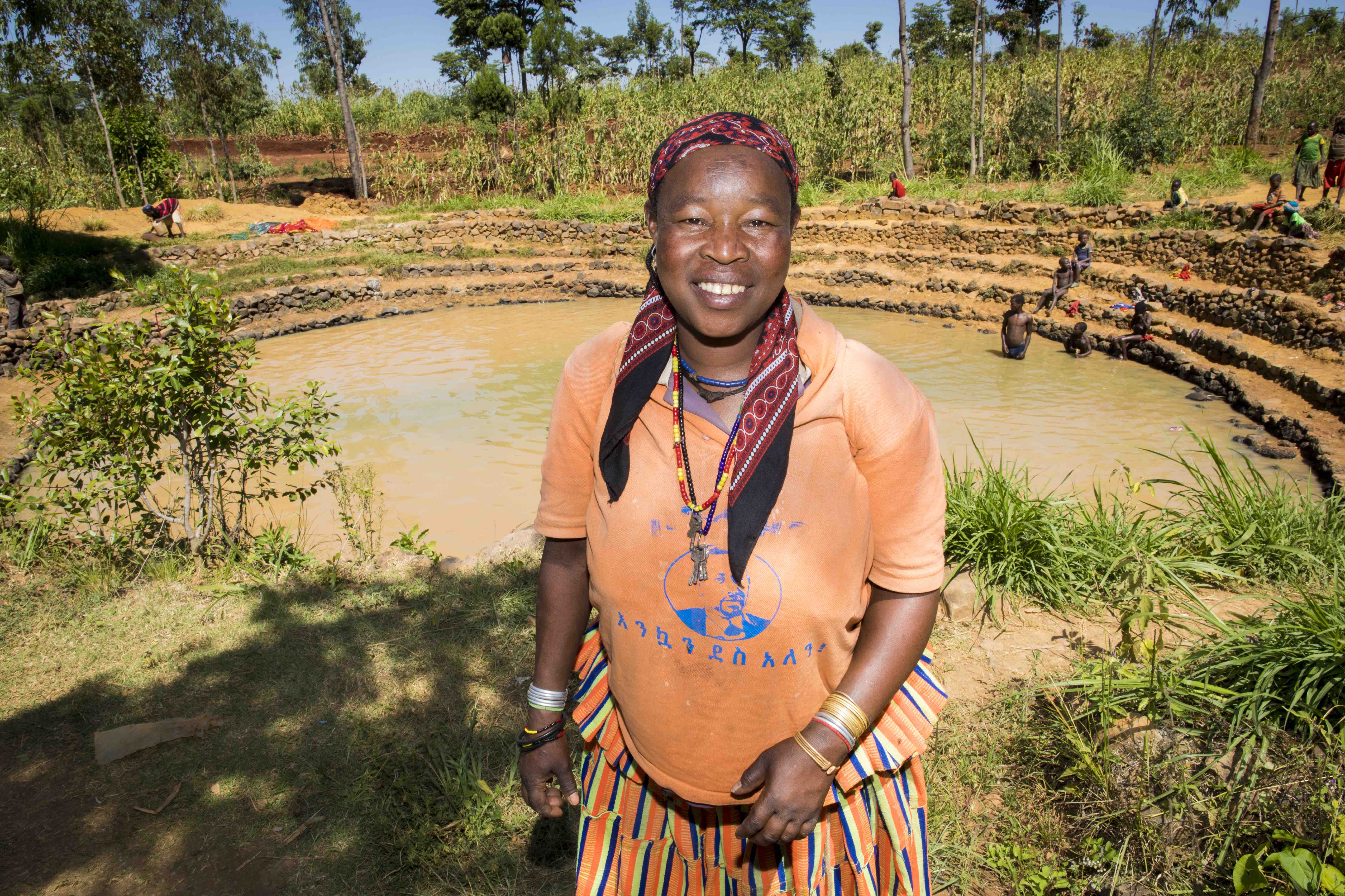 Pregnant mum-of-ten Kawite Koyrita (45) lives in Fasha Kebele in the Konso region of Ethiopia. Despite the effects of climate change, Kawite is thriving. The community pond provides water for her animals and crops.