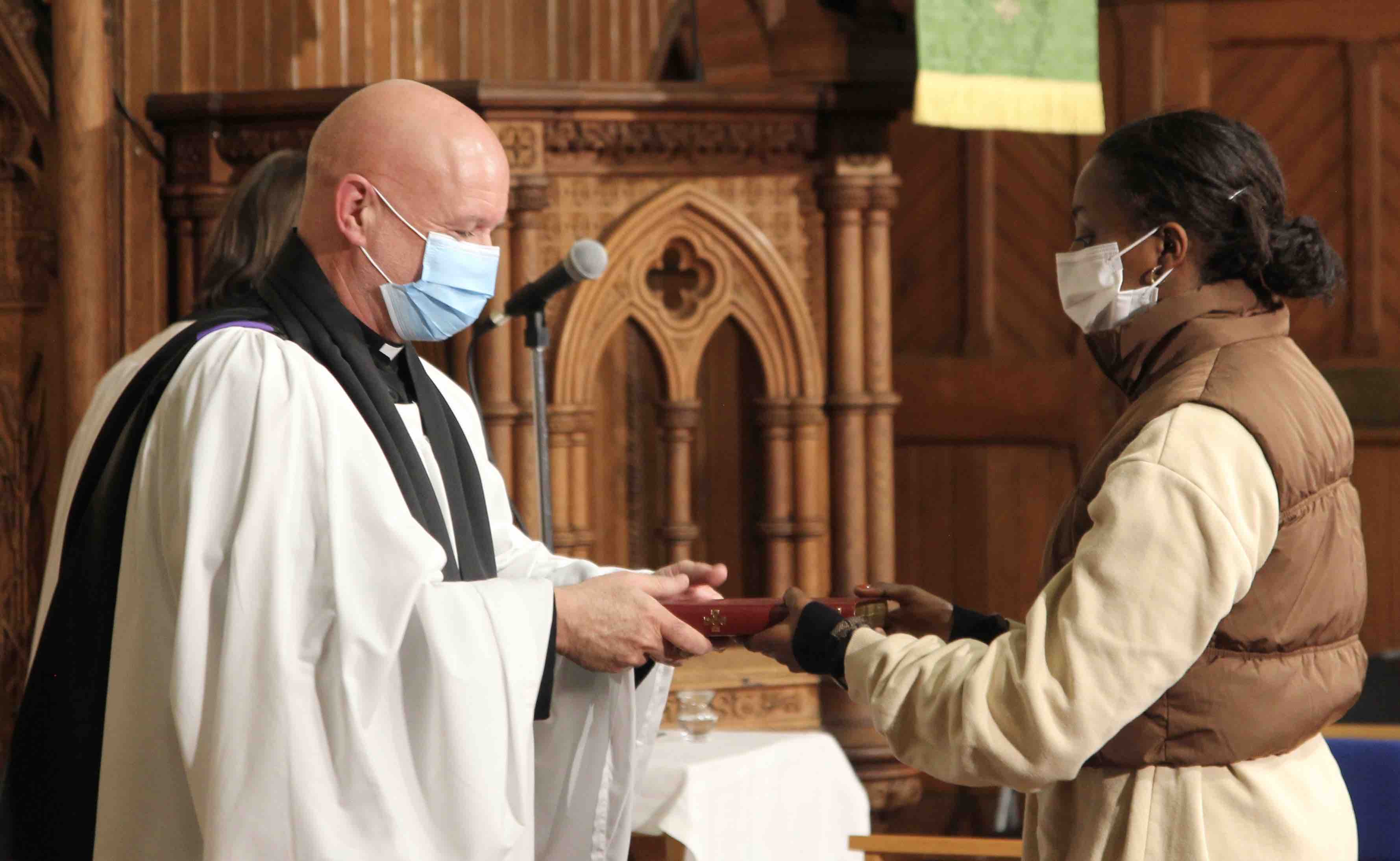 A Malahide parishioner hands one of the symbols of ministry to Canon David Gillespie during the Service of Institution in St Andrew's Church.