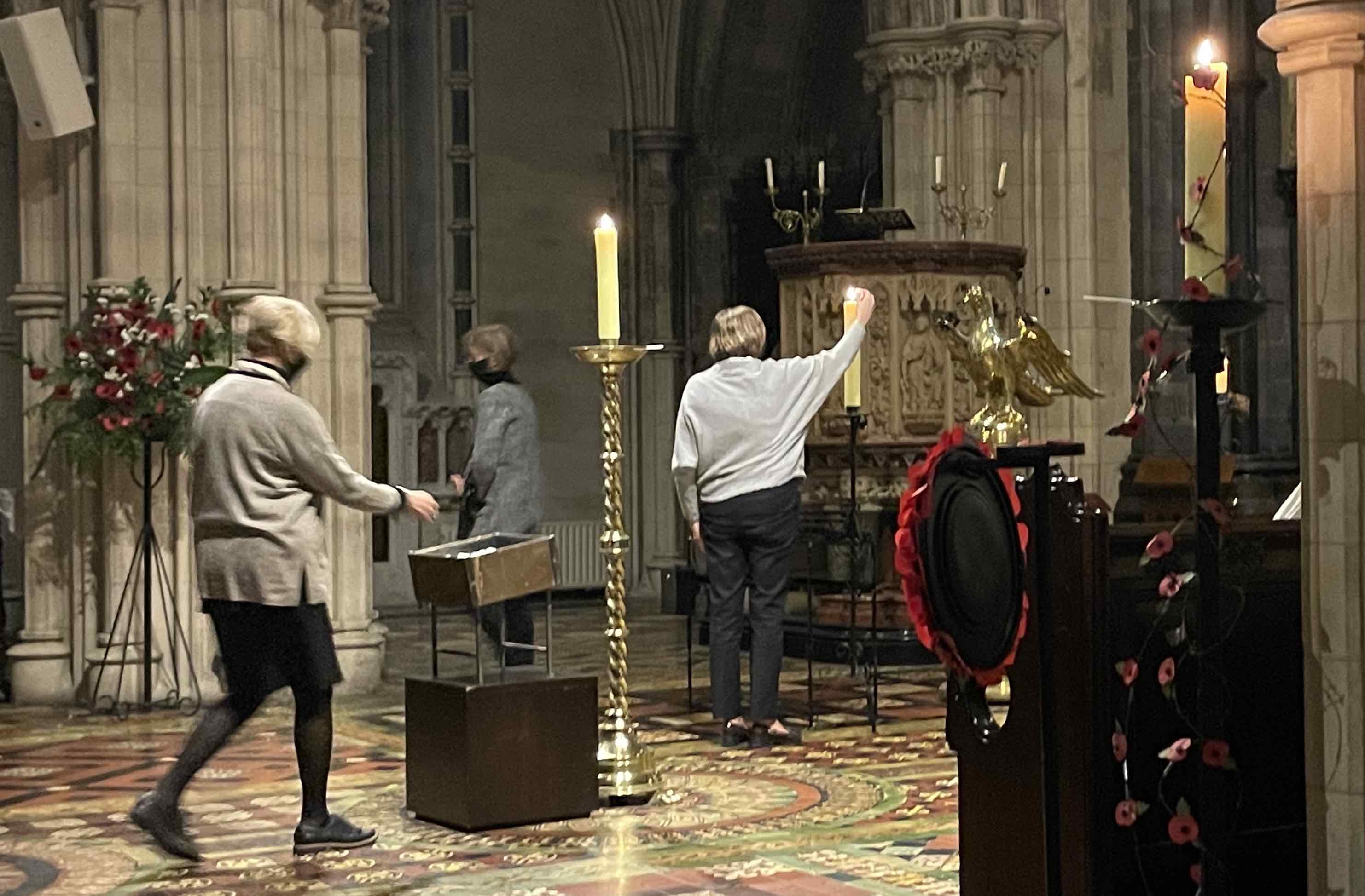 Members of the congregation light candles in memory of loved ones.