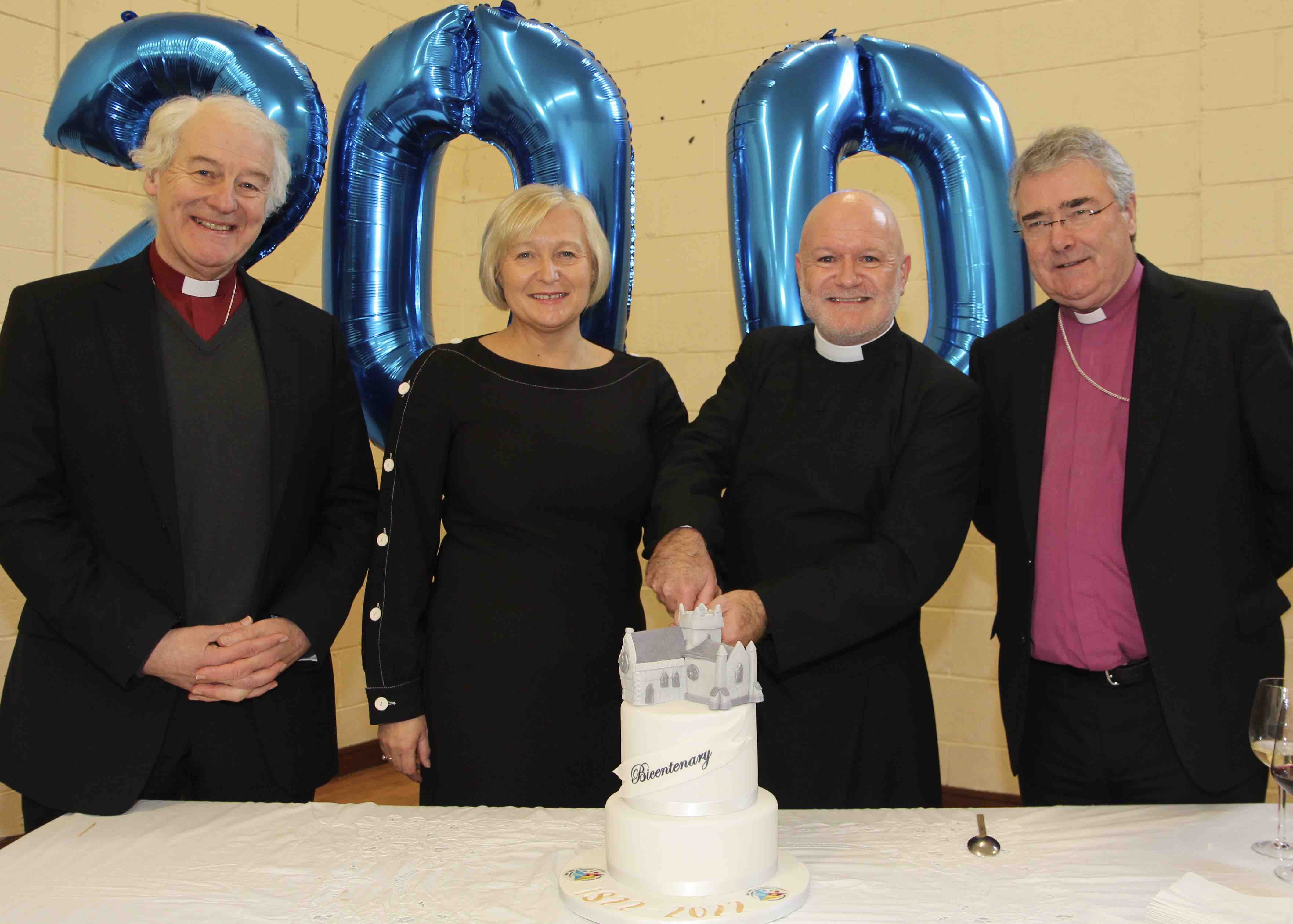 Cutting the cake, Canon David Gillespie and Tanya Sewell with Archbishop Michael Jackson and Archbishop John McDowell.