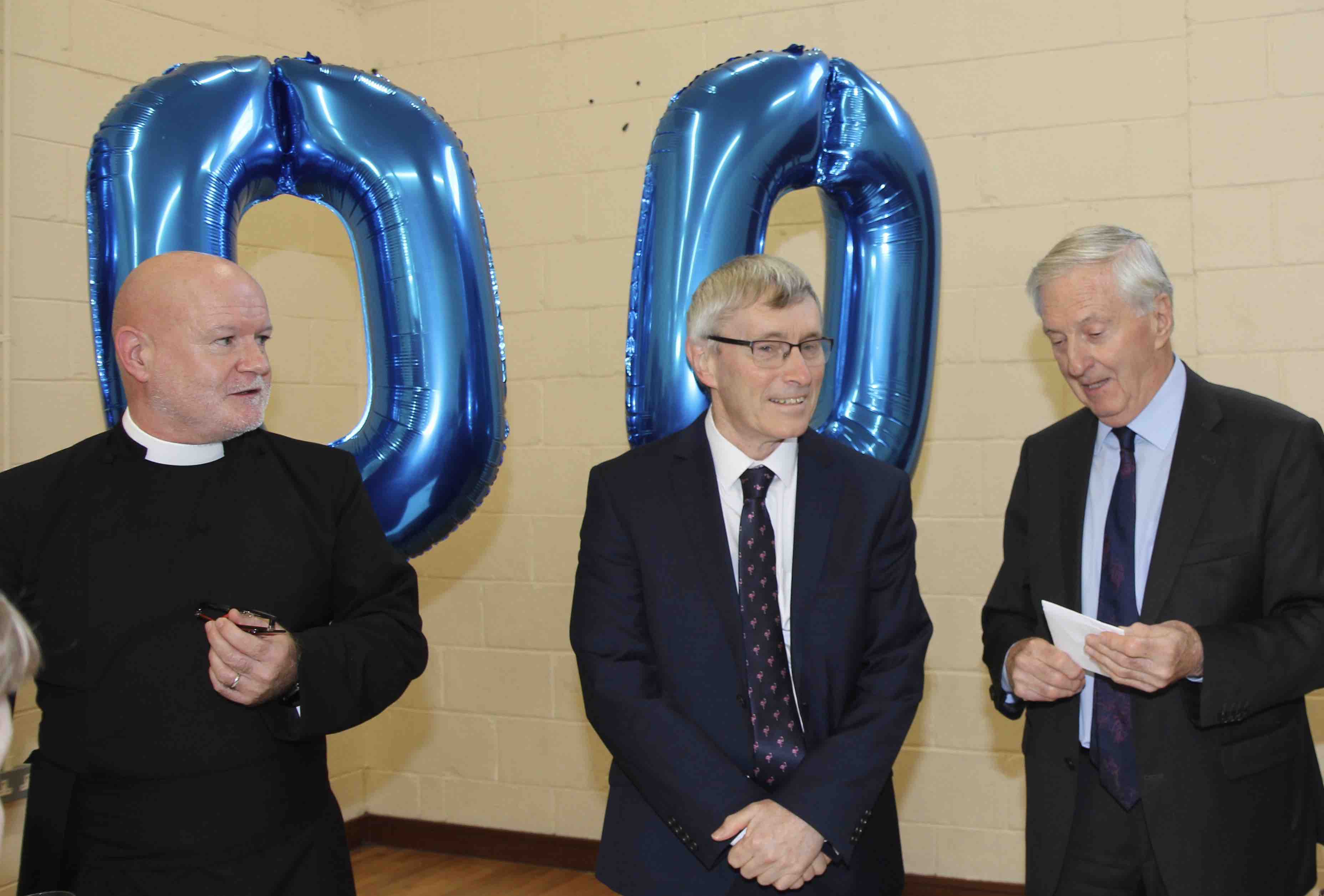 Brian Brown makes a presentation to Dr Tom Healy. Also pictured is Canon David Gillespie.