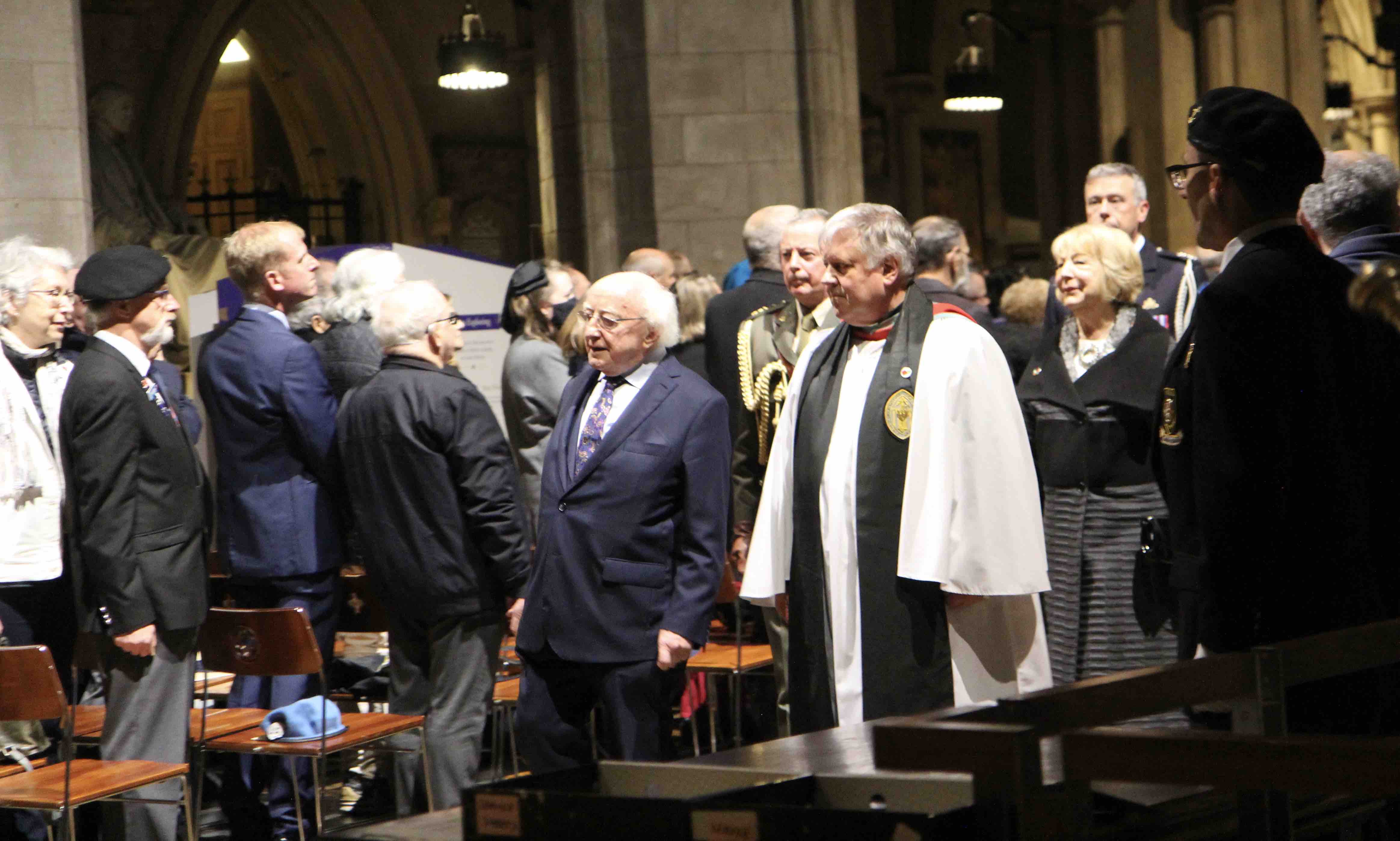 The Dean escorts President Higgins from the service.