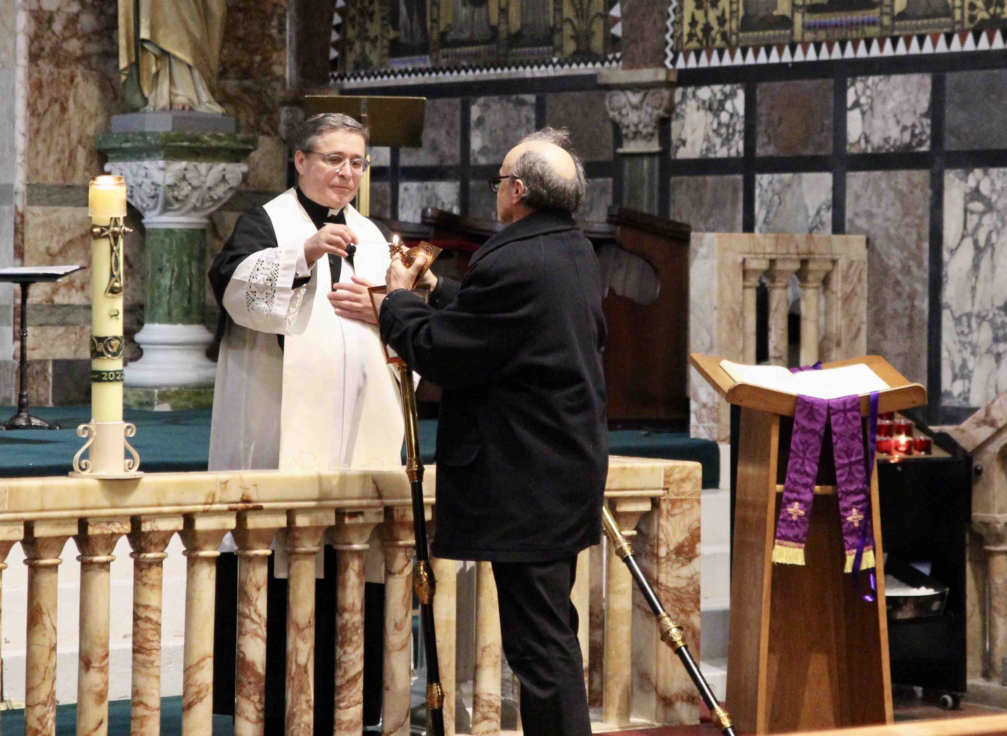 The lanterns are lit for the 18th Walk of Light by Fr Gary Chamberland and the Revd Martin Sauter in Newman University Church.