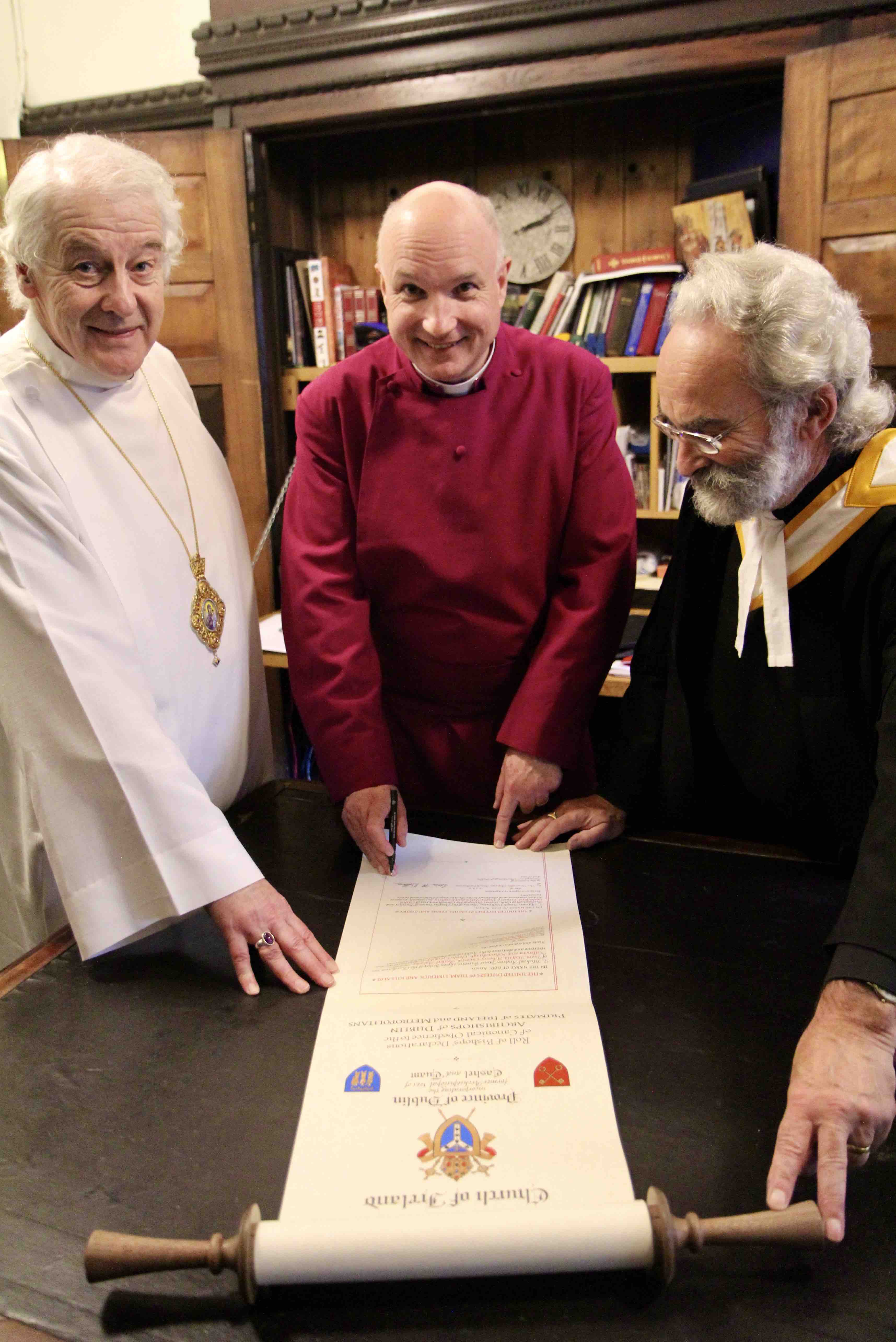 Bishop Adrian Wilkinson signs the new Episcopal role in the presence of Archbishop Michael Jackson and the Revd Robert Marshall, Diocesan and Provincial Registrar.