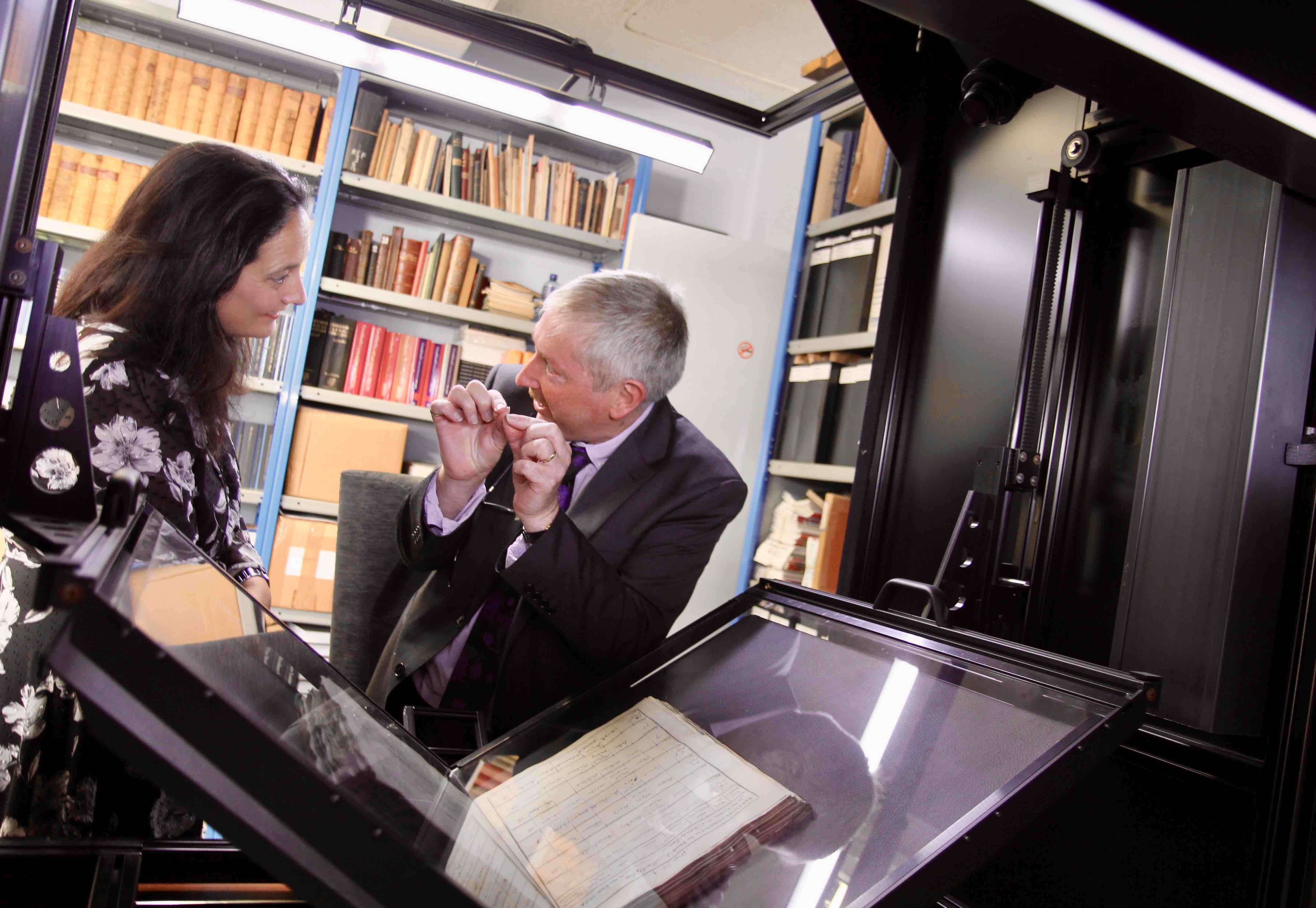 Digital Archivist Mike O'Neill shows Minister Martin the work of the 'Lizard' scanner.