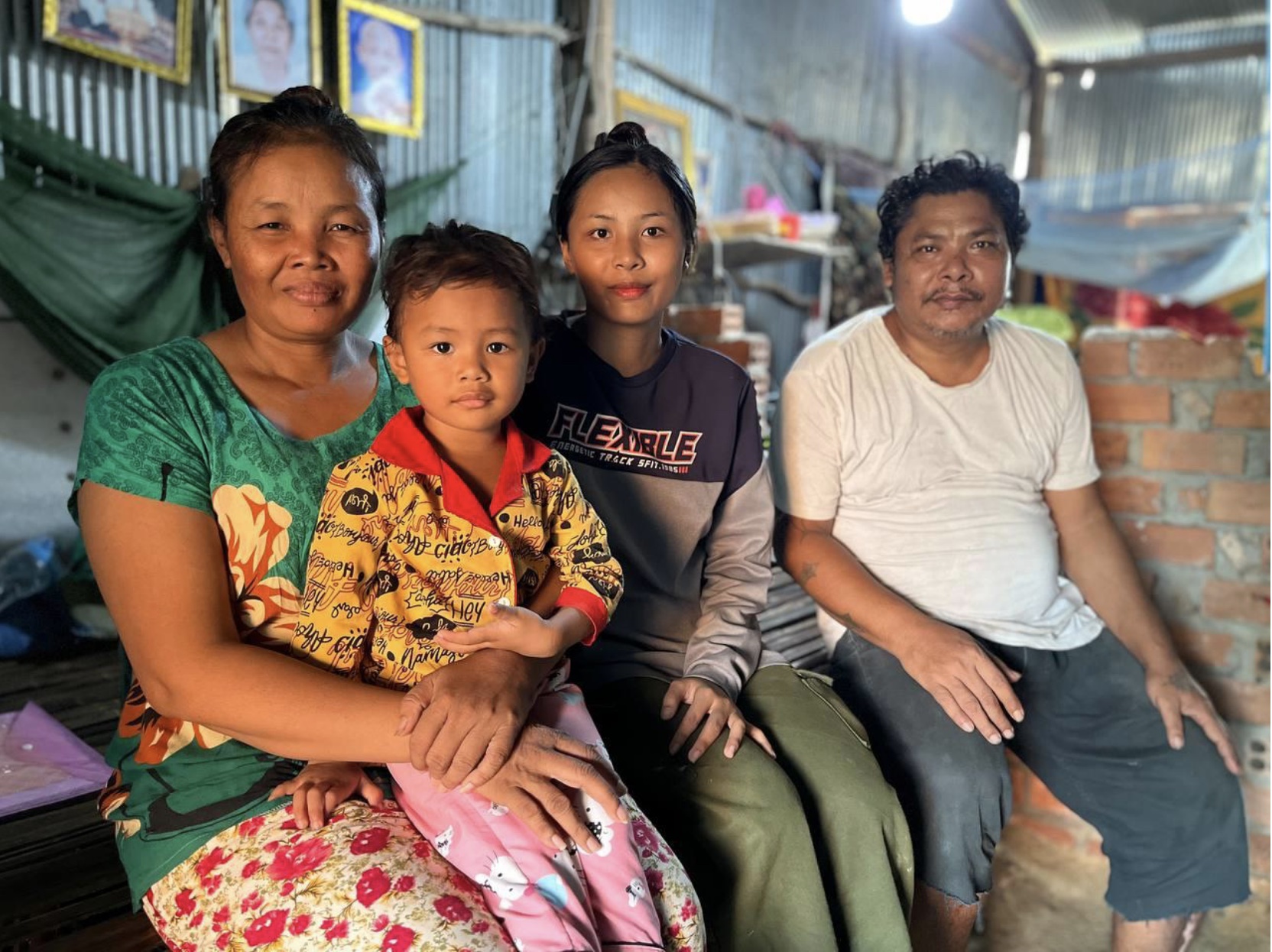 Sreymao with her grandchild  Sreynich and her daughter Sreyneath, with Kosal, her husband, in the white t-shirt - photo Habitat for Humanity.