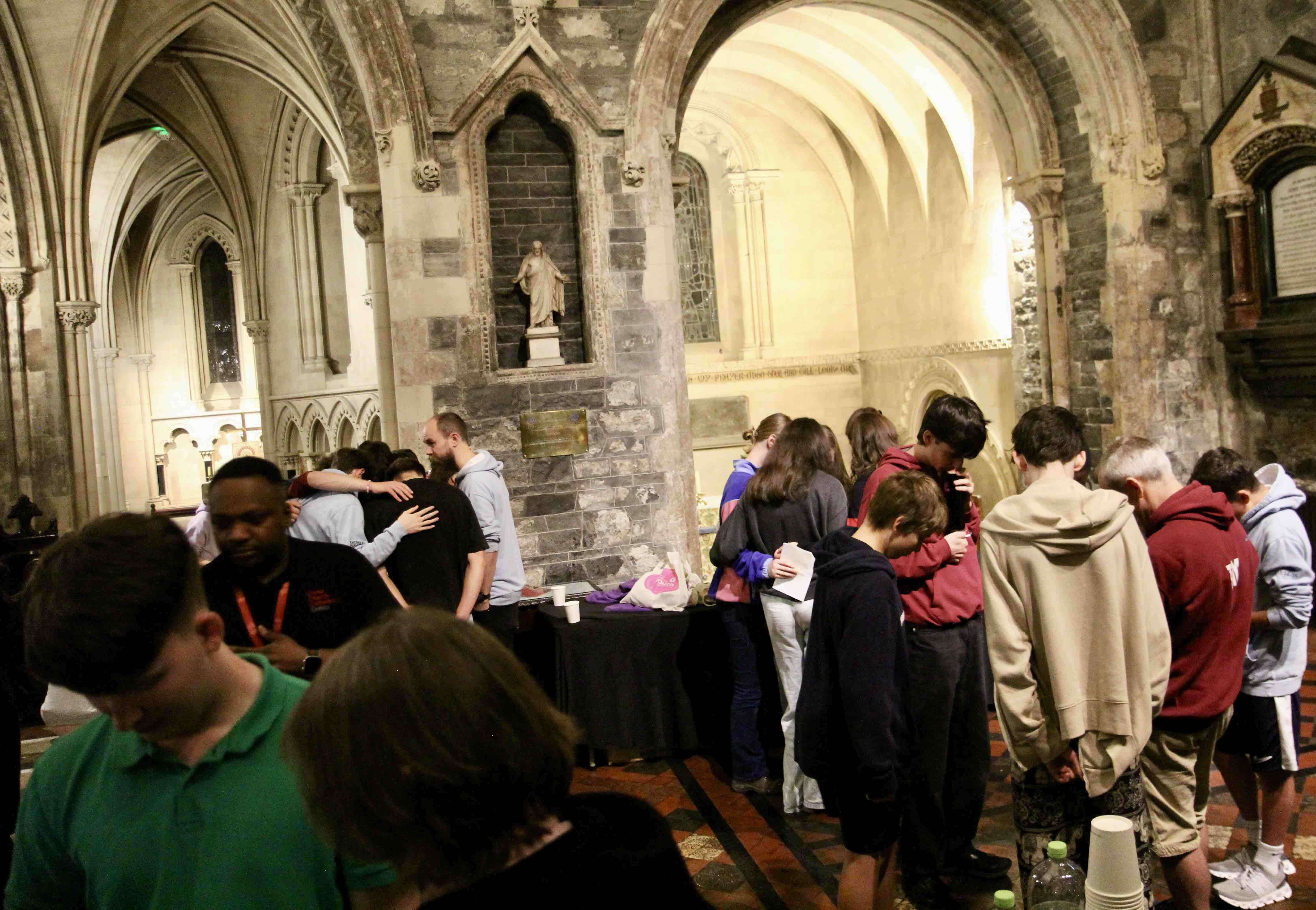 Young people and their youth leaders praying following the service.