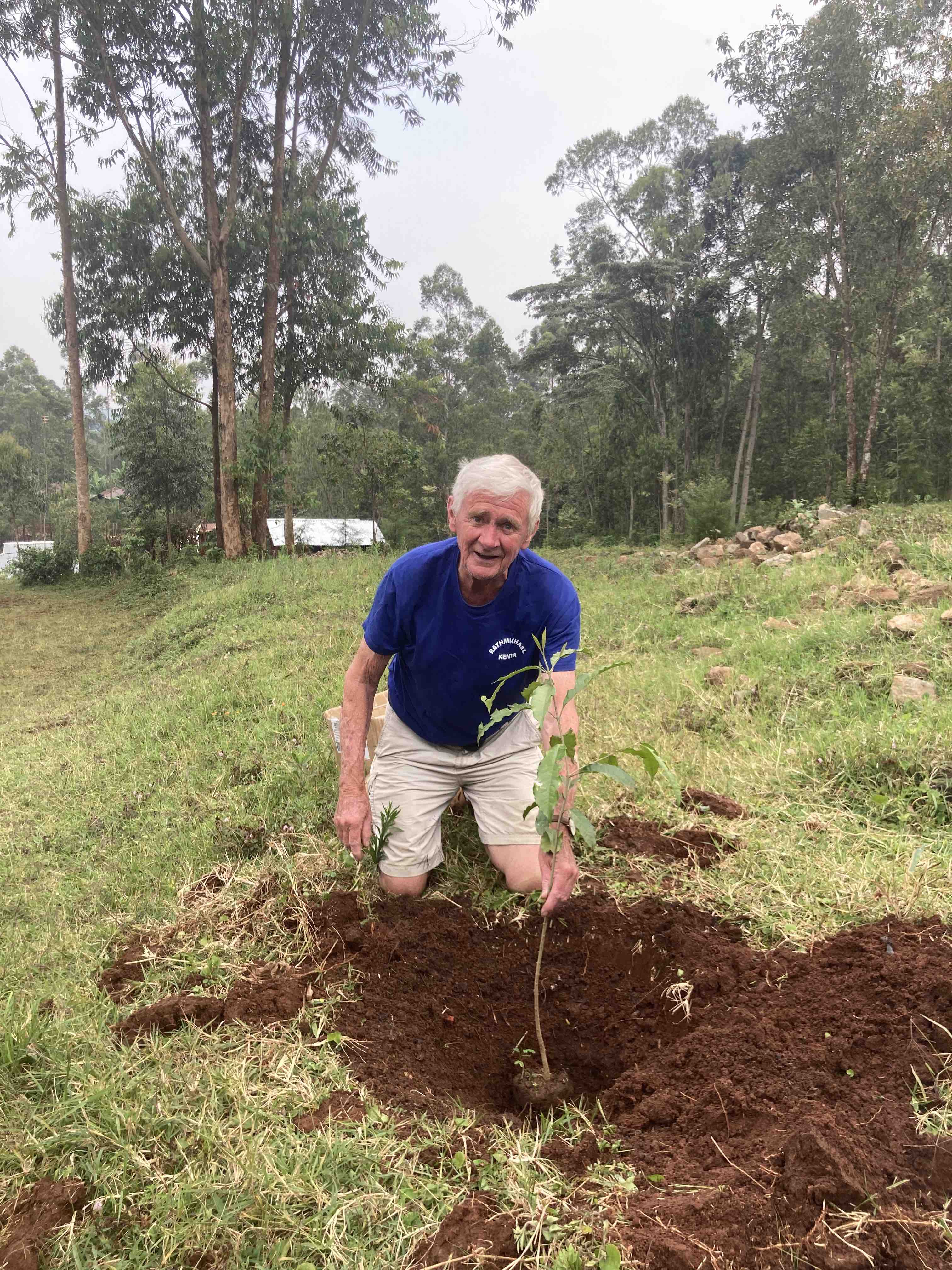 Geoffrey Perrin planting an elgon teak tree in Wandeche.